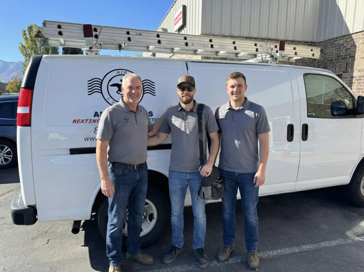 Three generations of the Air Express HVAC team standing in front of their Air Express van in Lehi Utah